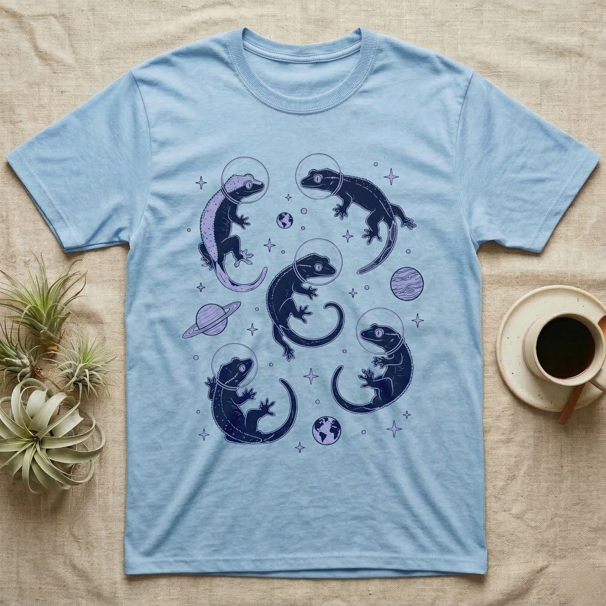 Crested Gecko Cosmic T-Shirt in Light Blue — Vintage screen-print illustration of crested geckos in astronaut helmets floating in space, deep cosmic indigo monochromatic on dark background.