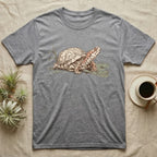 Box Turtle Shell T-Shirt in Sport Grey — Naturalist-plate illustration of a box turtle with its shell shown as living body, above a serif welfare creed caption.
