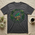 Dark grey t-shirt featuring a frog on a mushroom with a floral wreath and text.