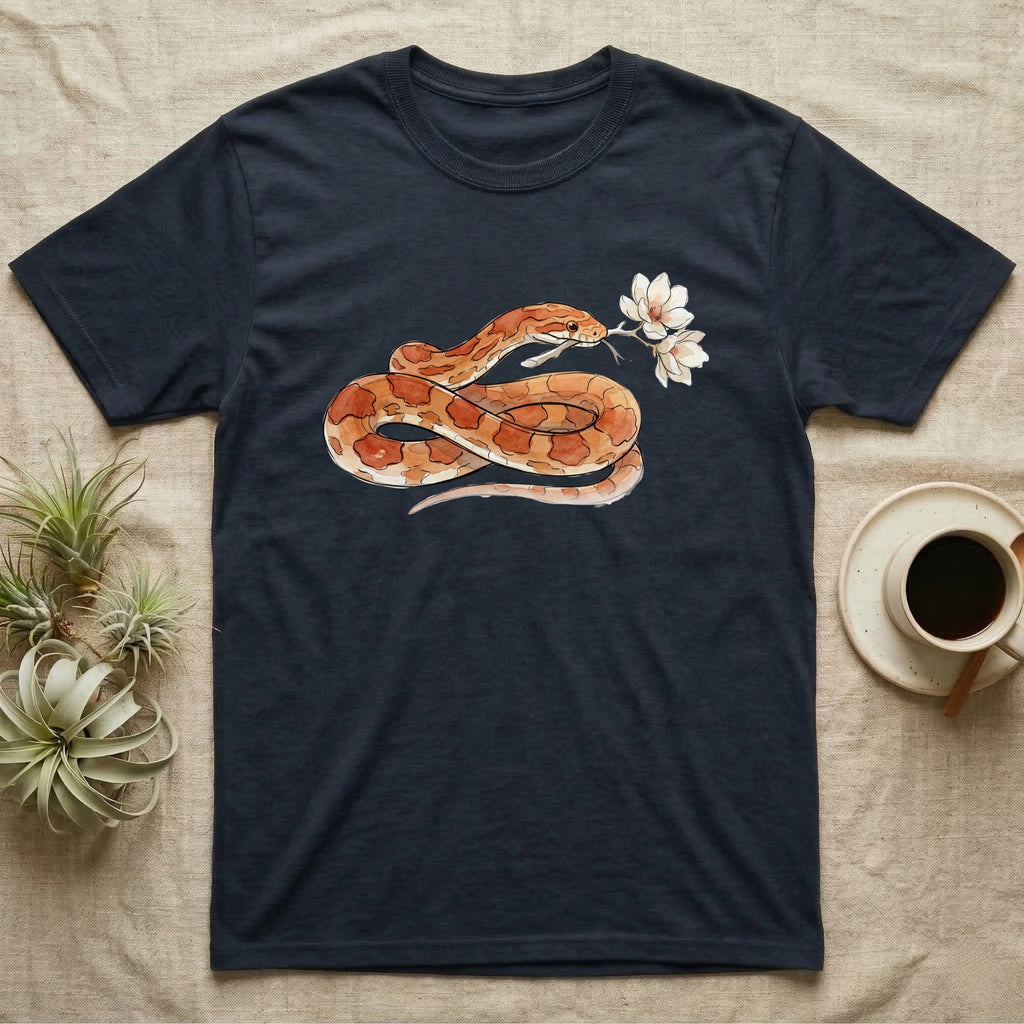 Corn Snake Blossom T-Shirt in Navy — Watercolor illustration of an orange-and-cream corn snake holding a magnolia blossom sprig, on a dark grey t-shirt.