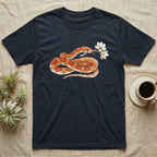 Corn Snake Blossom T-Shirt in Navy — Watercolor illustration of an orange-and-cream corn snake holding a magnolia blossom sprig, on a dark grey t-shirt.