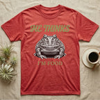 Pacman Frog He Thinks I'm Food T-Shirt in Heather Red — Engraved white-line illustration of a pacman frog staring straight ahead below retro script lettering reading HE THINKS.