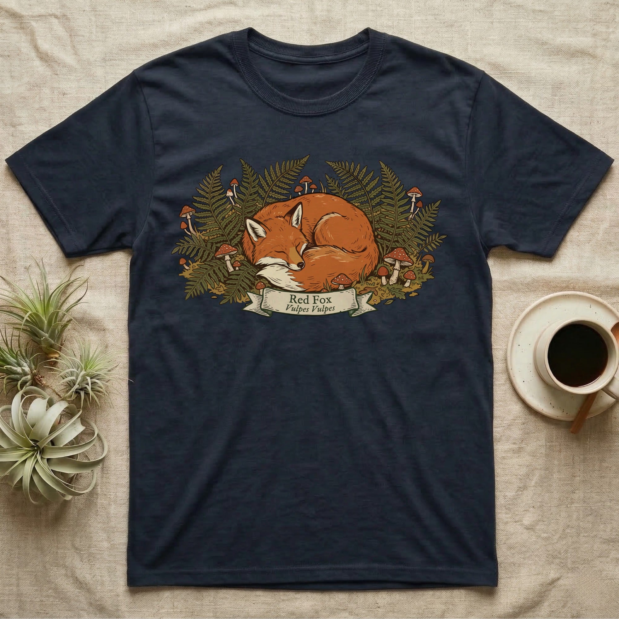 Navy t-shirt with sleeping red fox and forest flora illustration.