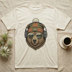 Bear wearing beanie and headphones, mirrored sunglasses reflect a forest.