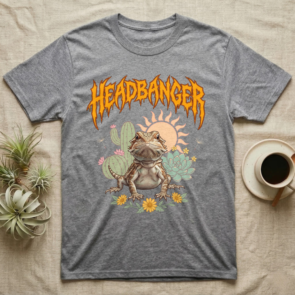 Central Bearded Dragon Feral T-Shirt in Sport Grey — Baby bearded dragon in a pastel desert scene under a spiky amber metal wordmark reading HEADBANGER.