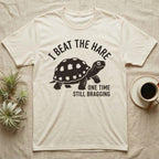 Red-Foot Tortoise Bragging T-Shirt in Natural — Smug red-footed tortoise walking chin-up under I Beat the Hare, One Time, Still Bragging