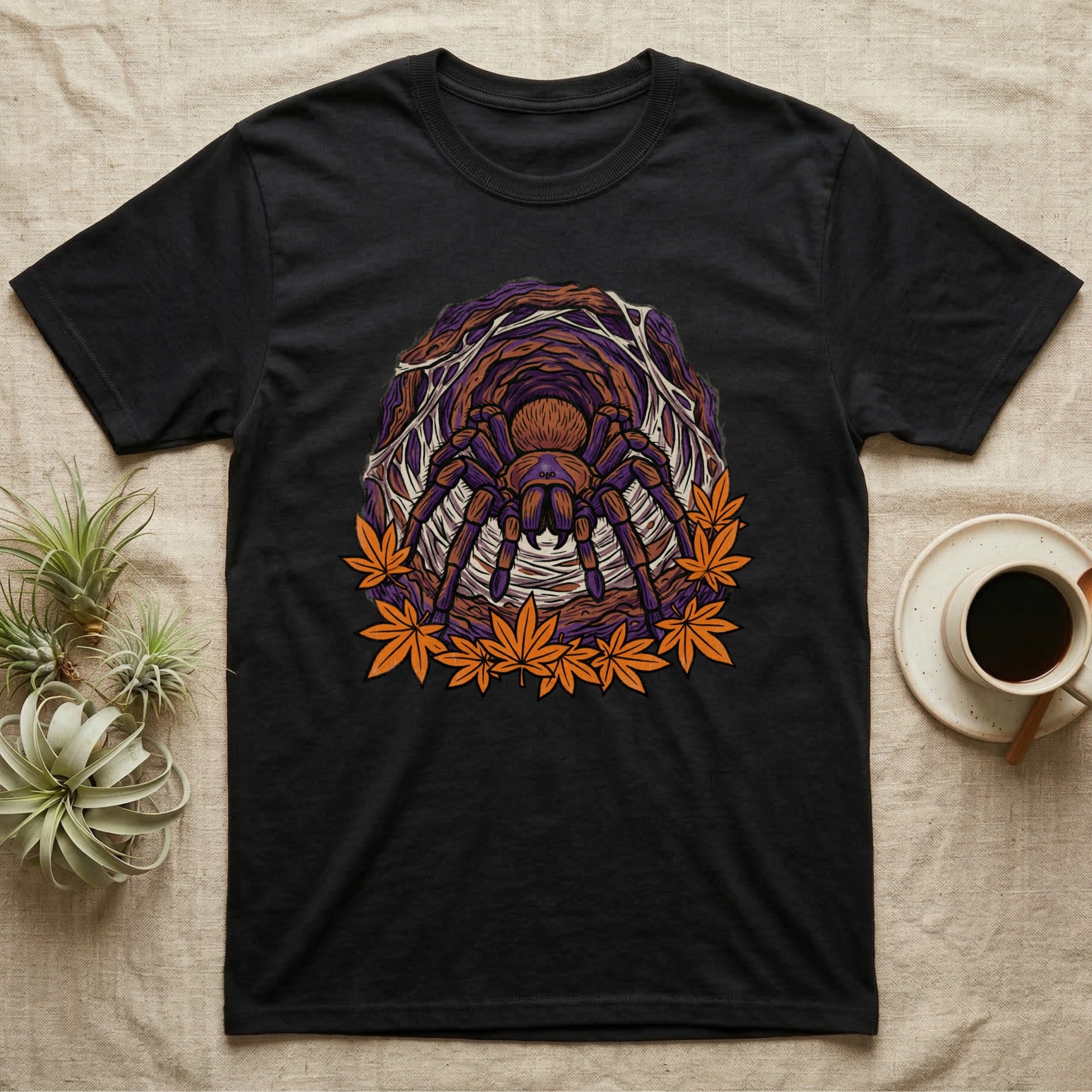 Black t-shirt with tarantula and autumn leaves graphic.
