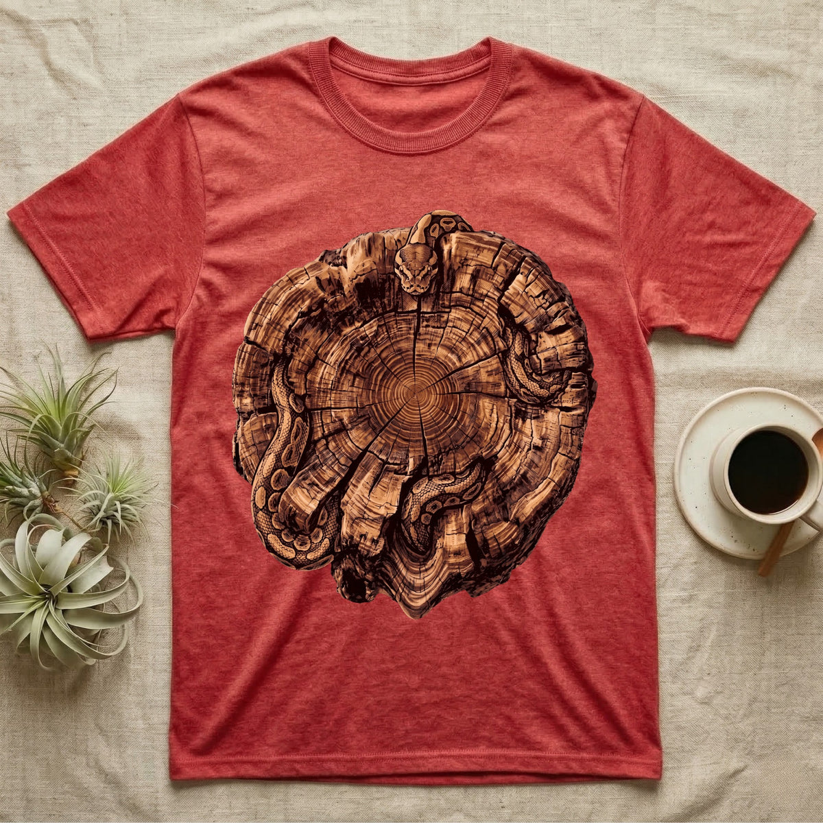 Ball Python Stump Coil T-Shirt in Heather Red — Pyrography-style illustration of a ball python threaded through the charred radial cracks of a cross-section log, no on-shirt text.