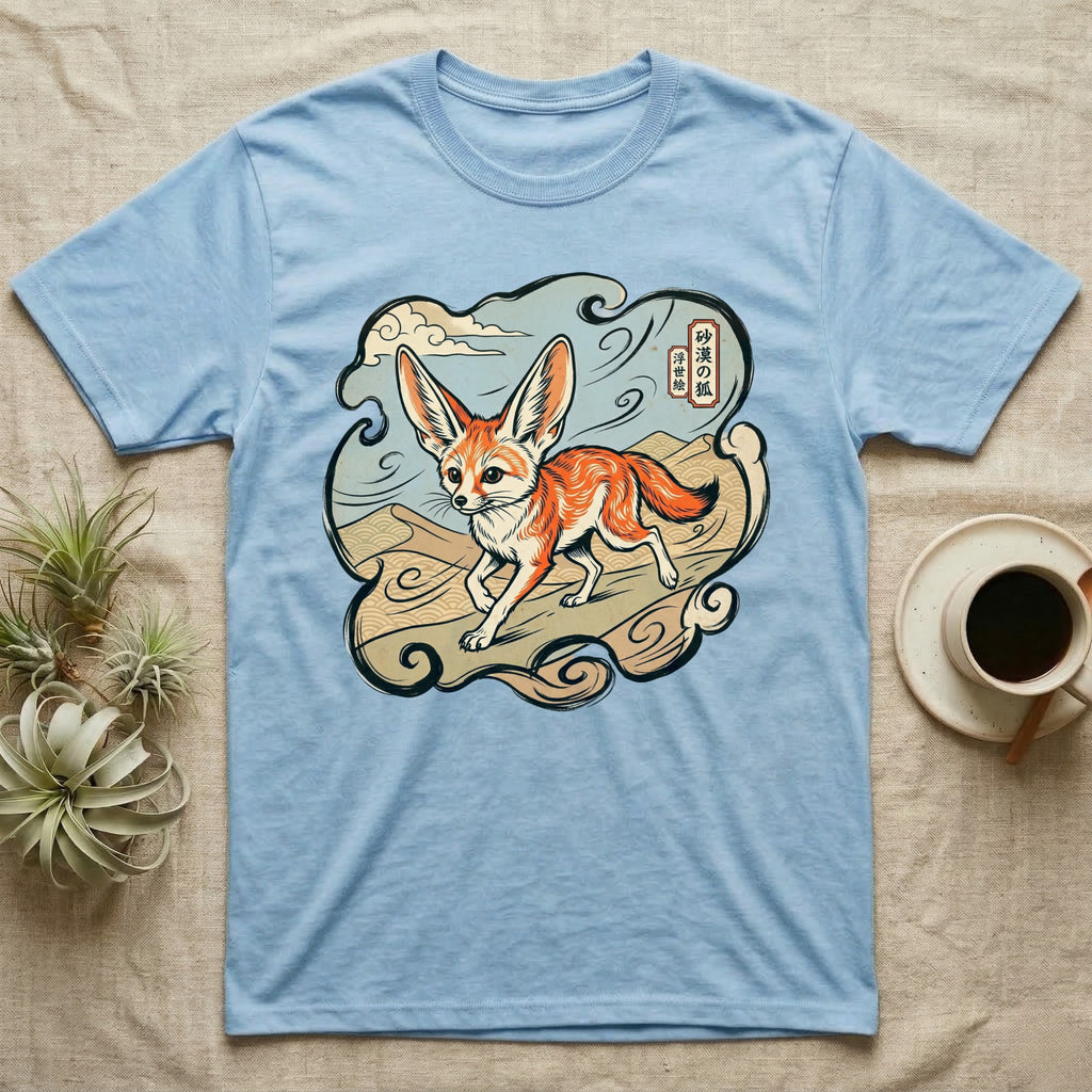 Light blue t-shirt with a cartoon fennec fox on a desert landscape.