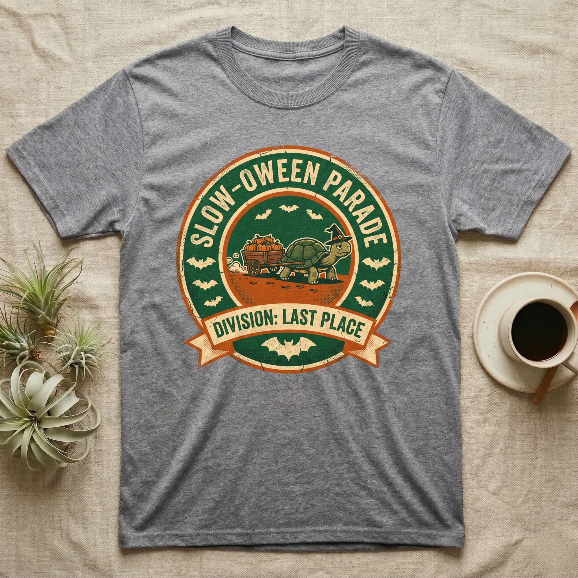 Tortoise Slow-oween Parade T-Shirt in Sport Grey — Distressed badge of a witch-hatted tortoise pulling a pumpkin wagon, "Slow-oween Parade, Division Last Place."