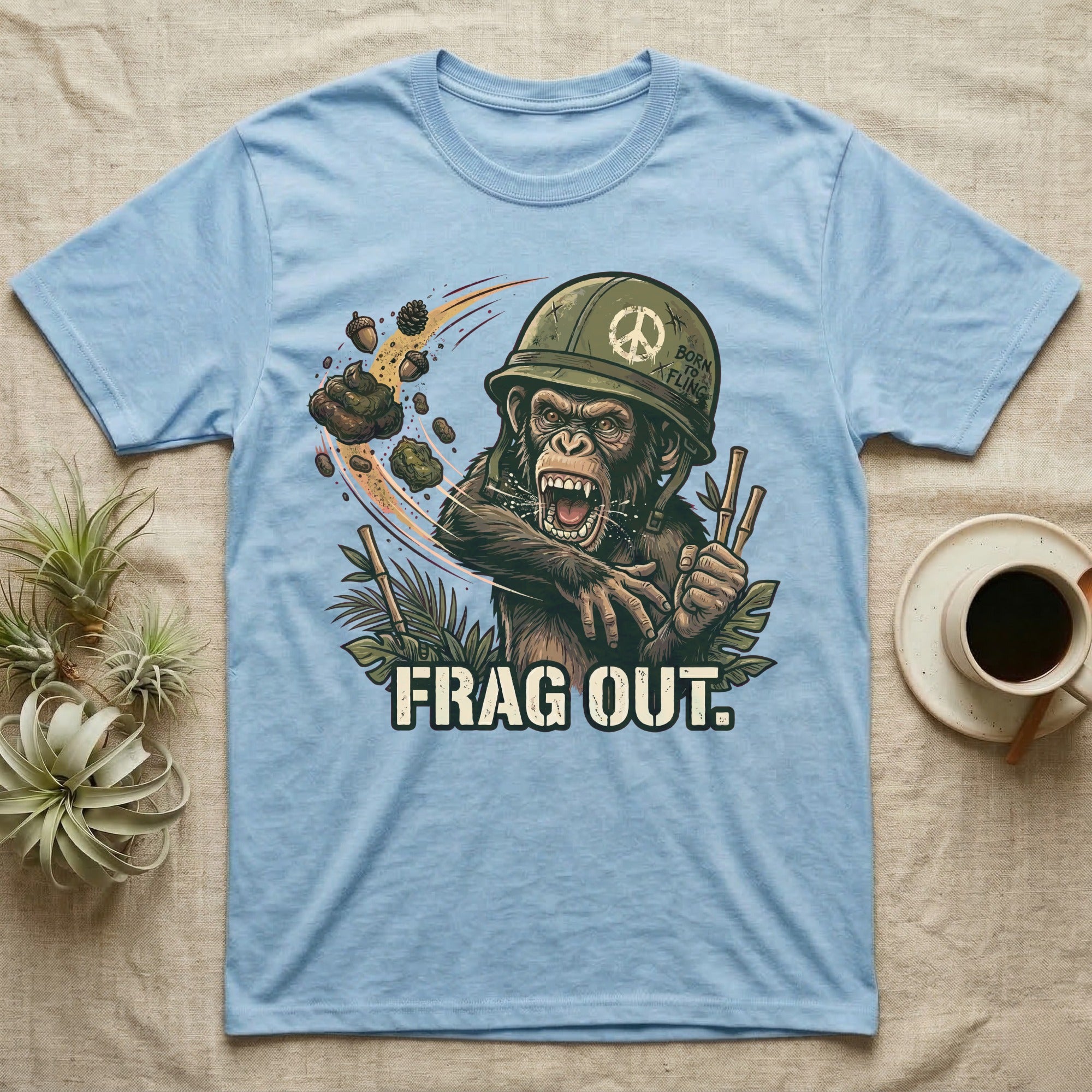 Light blue t-shirt with a chimpanzee in a helmet, holding bamboo, with "FRAG OUT." text.