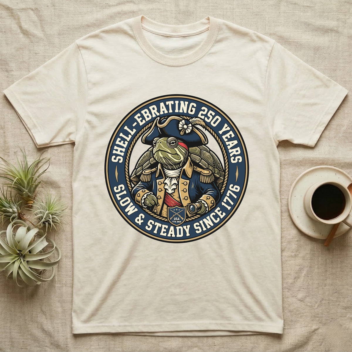 Sea Turtle General T-Shirt in Natural — Circular crest of a sea turtle dressed as a Continental general with text Shell-Ebrating 250 Years.