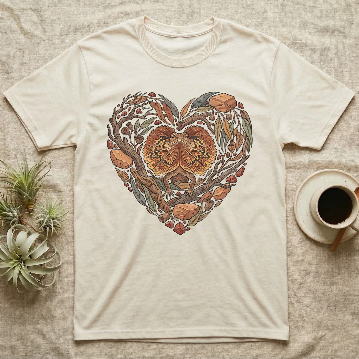 Cream t-shirt with heart-shaped nature design featuring a lizard and fall leaves.