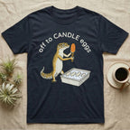 Leopard Gecko Candling T-Shirt in Navy — Leopard gecko holding a torch under a glowing orange egg beside a tub of eggs, under the words off to CANDLE eggs