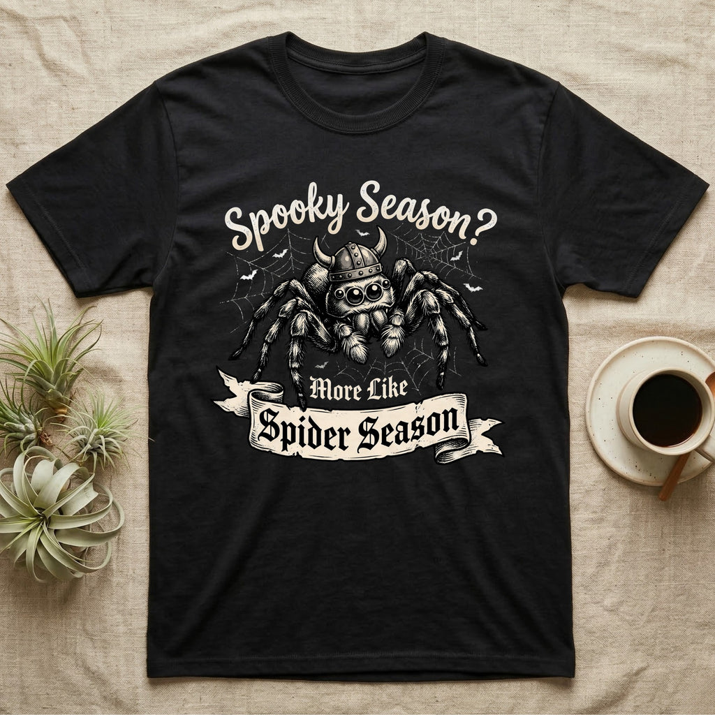 Jumping Spider Viking Helmet T-Shirt in Black — Ink-sketch jumping spider in a Viking helmet over a web, banner reading "More Like Spider Season."