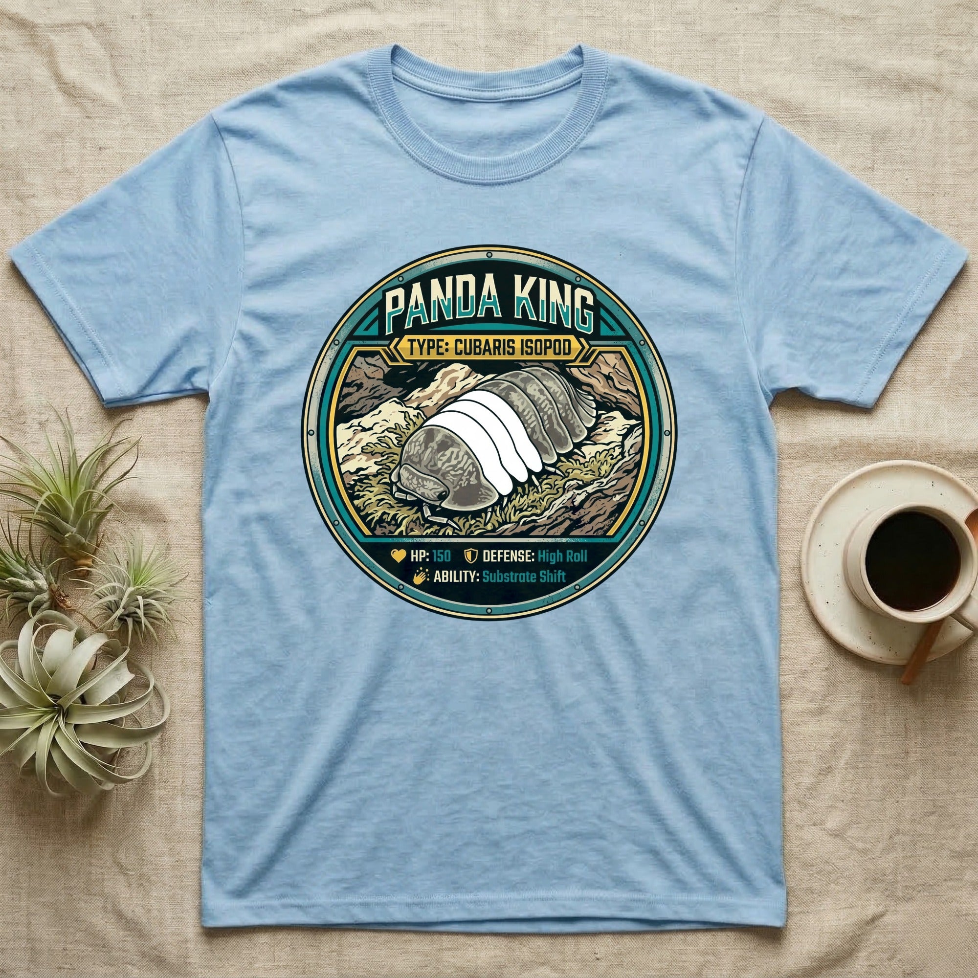 Panda King Isopod Trading Card T-Shirt in Light Blue — Metal stat-card badge showing a Panda King Cubaris isopod on limestone with HP and ability lines.