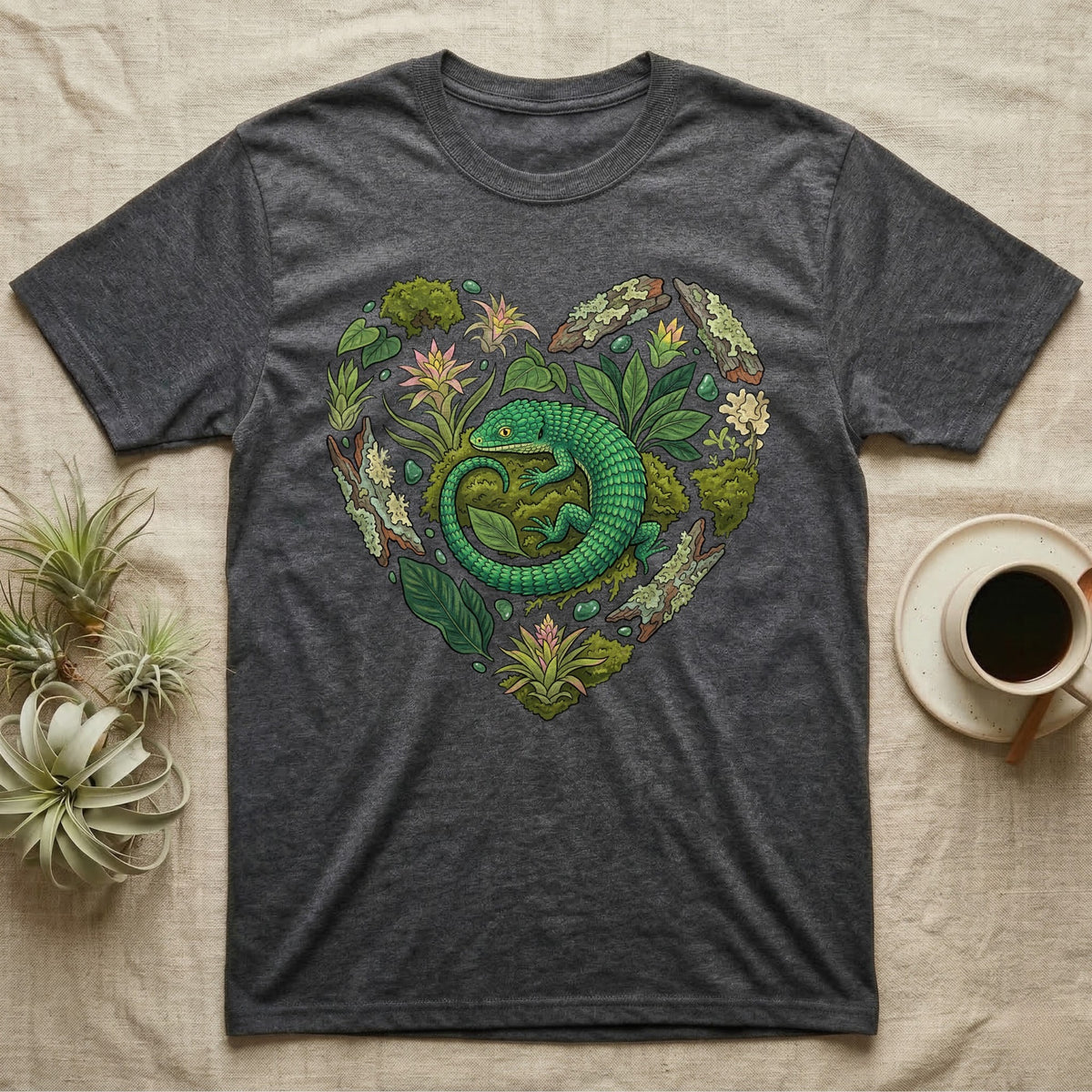 Dark gray t-shirt with green lizard and foliage forming a heart shape.