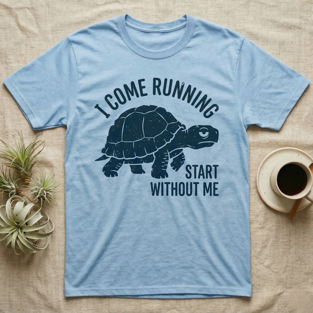 Red-Foot Tortoise Running T-Shirt in Light Blue — Navy silhouette of a red-footed tortoise walking under arched words I Come Running, beside Start Without Me