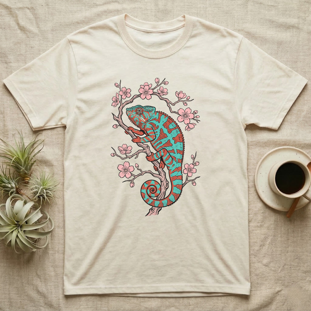 Chameleon perched on a cherry blossom branch, cream t-shirt design.
