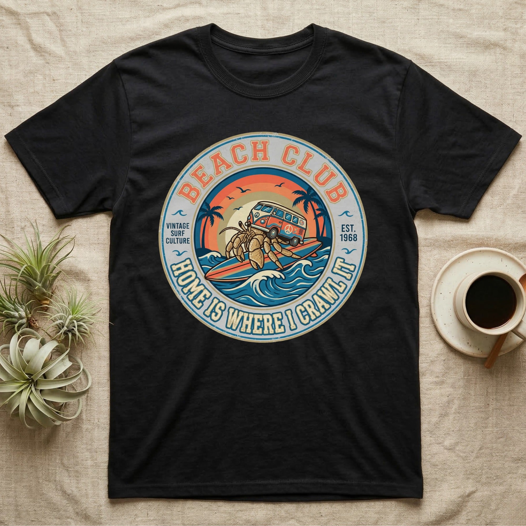 Black t-shirt with "Beach Club Home Is Where I Crawl It" surf-themed circular graphic.