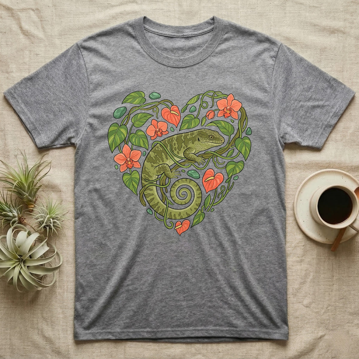 Grey t-shirt with a green lizard inside a heart-shaped floral design.