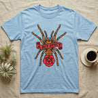 Tarantula A Bit Spicy T-Shirt in Light Blue — Tattoo-flash orange-baboon-tarantula in threat-pose with banner-scroll "A Bit Spicy" and a flash rose beneath.