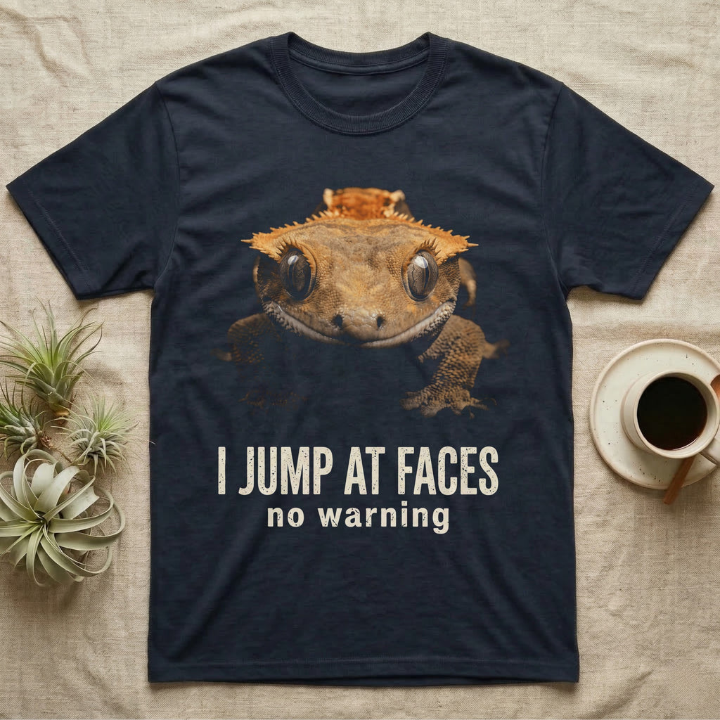 Photographic mugshot of a crested gecko braced wide-eyed above the hook I Jump At Faces, no warning. — shown on a Navy tee.