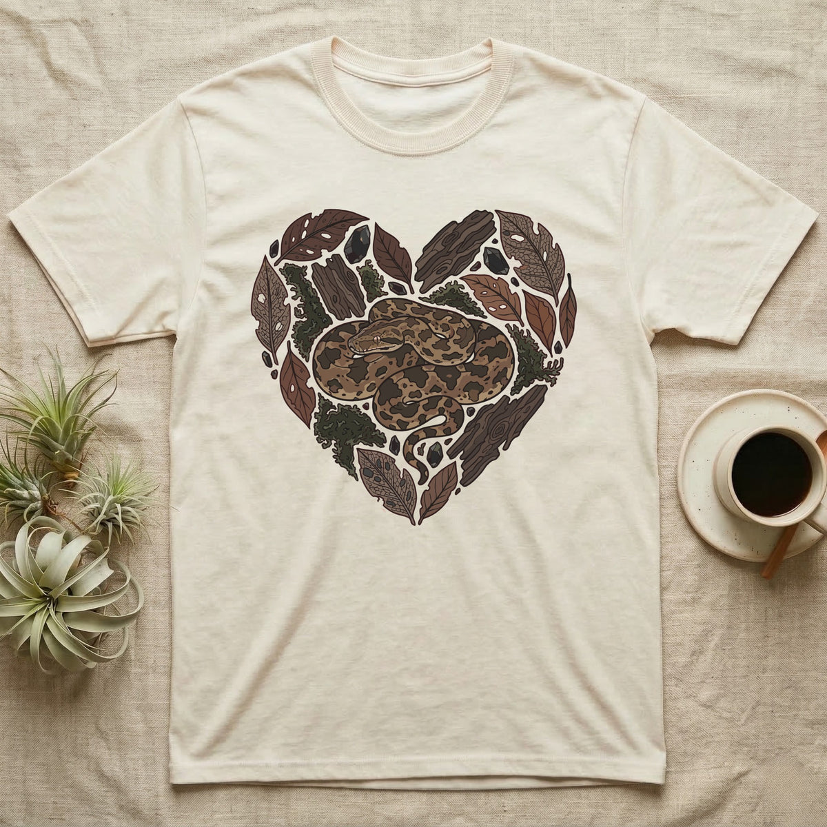 Cream t-shirt with a heart-shaped snake and natural wood design.