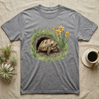 Russian Tortoise Spring T-Shirt in Sport Grey — Botanical illustration of a Russian tortoise stepping into spring grass framed by daffodils and early shoots.