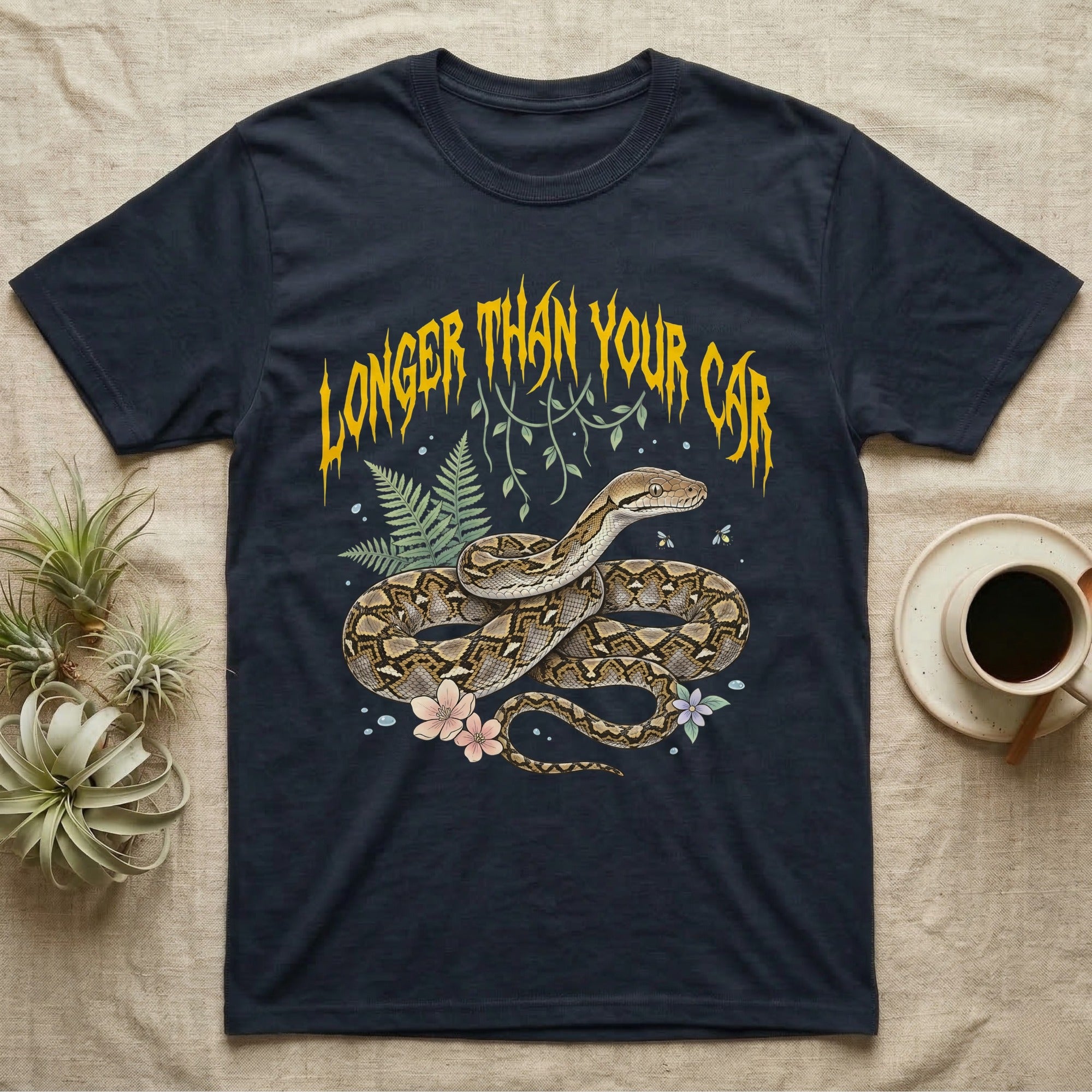 Reticulated Python Feral T-Shirt in Navy — Reticulated python in net-patterned coils under jagged molten-gold metal text LONGER THAN YOUR CAR with pastel ferns