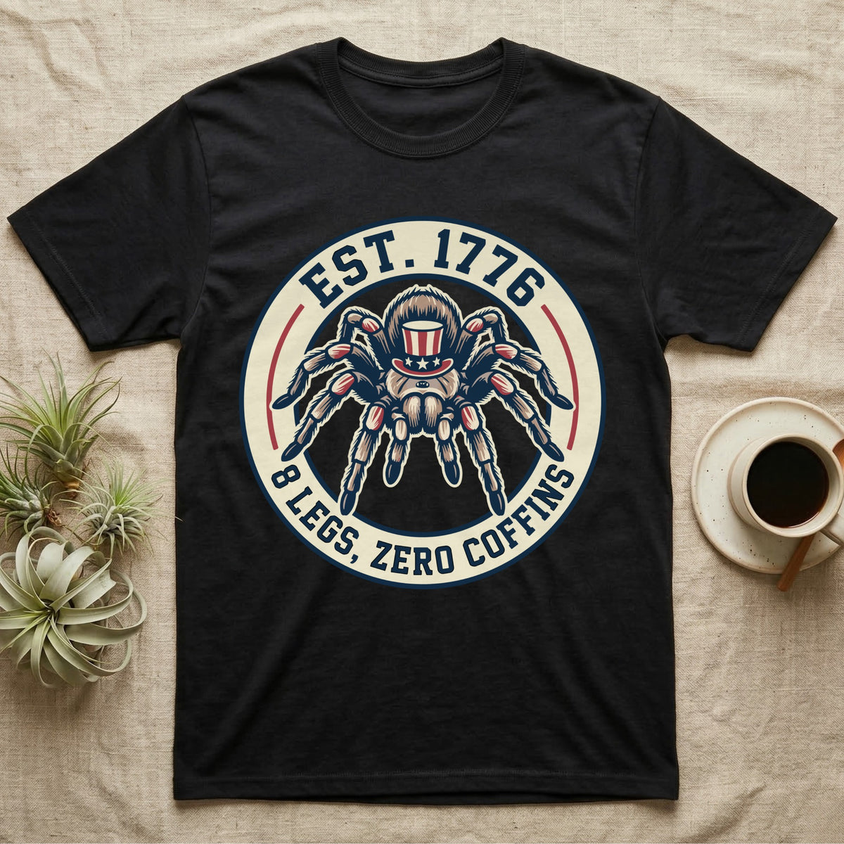 Tarantula Zero Coffins T-Shirt in Black — Circular patch emblem of a tarantula in a top hat with arched text Est. 1776 and 8 Legs Zero Coffins.
