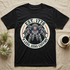 Tarantula Zero Coffins T-Shirt in Black — Circular patch emblem of a tarantula in a top hat with arched text Est. 1776 and 8 Legs Zero Coffins.
