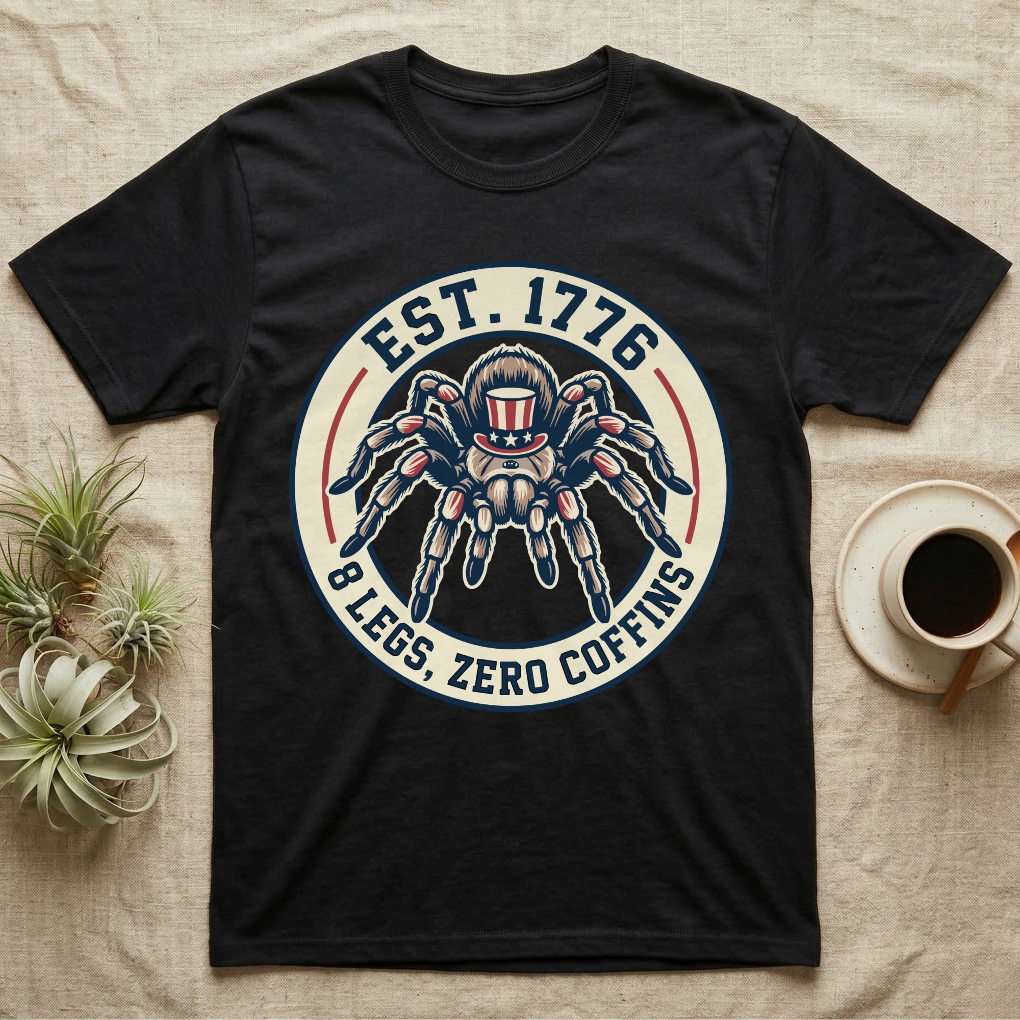 Tarantula Zero Coffins T-Shirt in Black — Circular patch emblem of a tarantula in a top hat with arched text Est. 1776 and 8 Legs Zero Coffins.