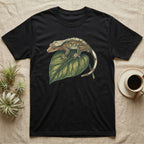 Black t-shirt with a crested gecko on a green leaf design.
