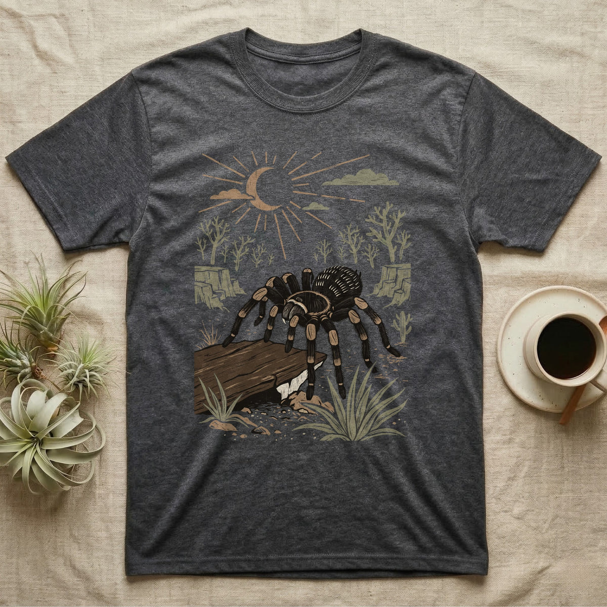 Red-Knee Tarantula Home Range T-Shirt in Dark Heather — Woodcut-style illustration of a Mexican red-knee tarantula at its burrow entrance under a rock slab with desert scrub behind, no on-shirt text.