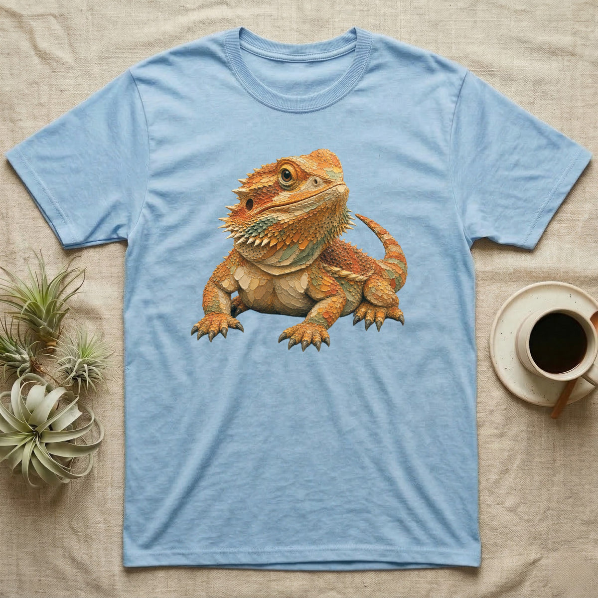 Light blue t-shirt with a colorful bearded dragon graphic print.