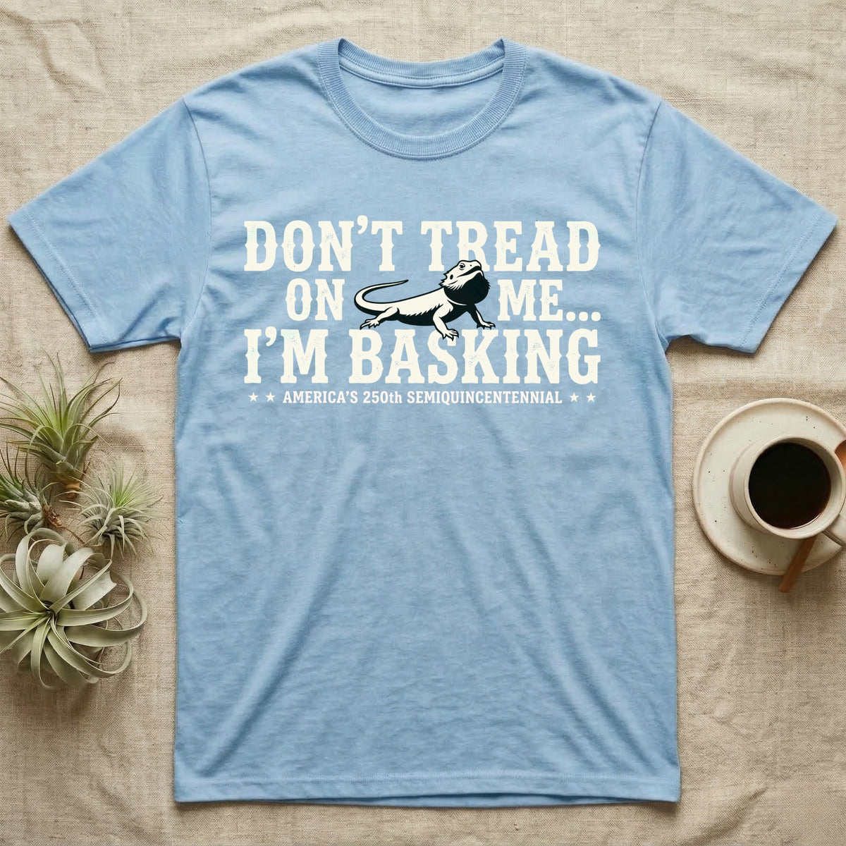 Bearded Dragon Basking Silhouette T-Shirt in Light Blue — Cream bearded dragon silhouette nested into distressed block text reading Don't Tread On Me, I'm Basking.