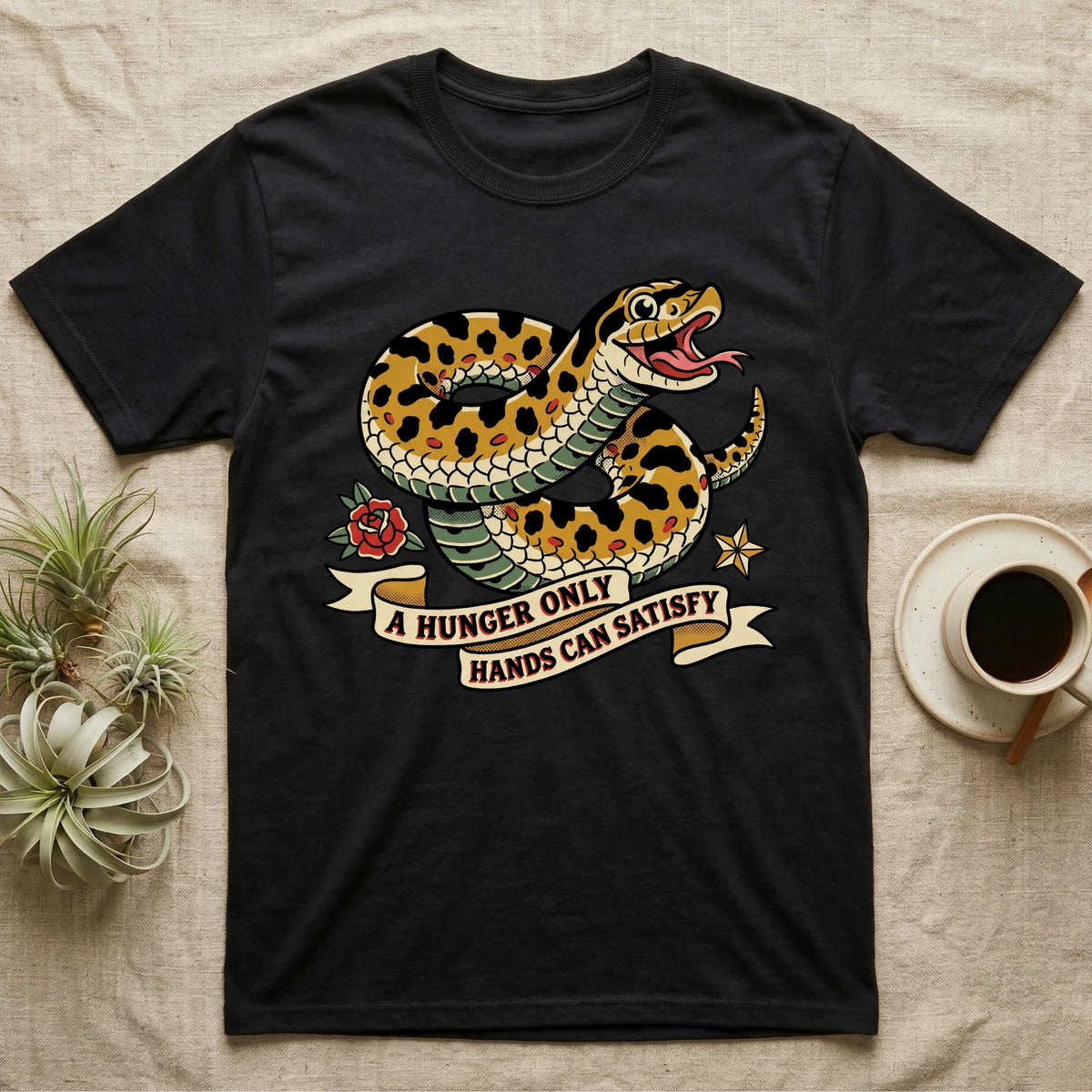 Hognose Hunger Flash T-Shirt in Black — American-traditional tattoo-flash illustration of a hognose snake in a heroic coil with a banner reading the feeding-hunger line.