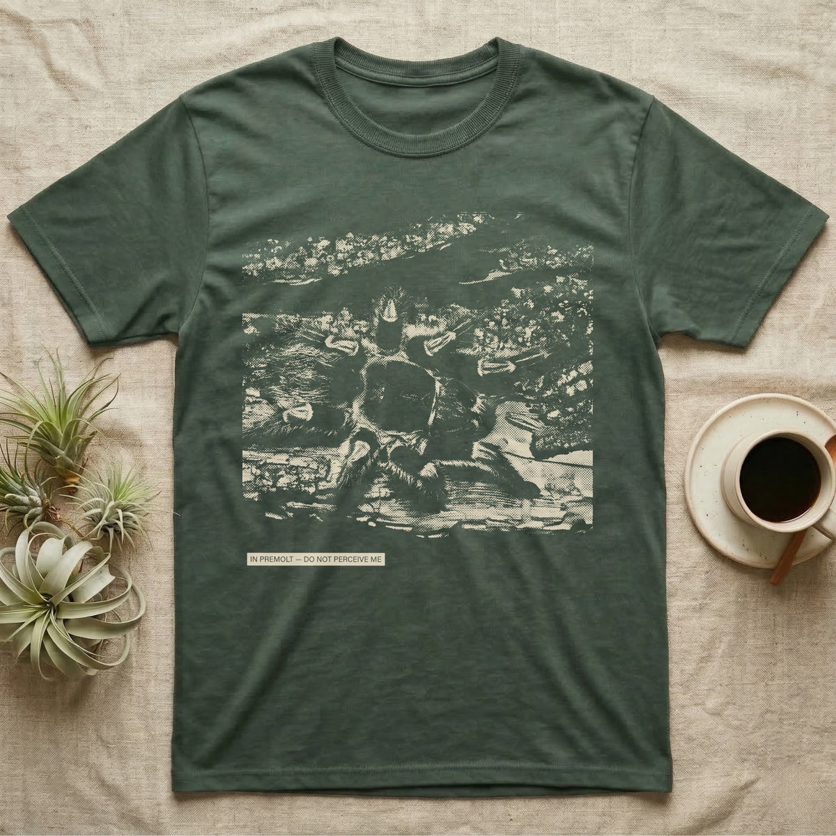 In Premolt Tarantula T-Shirt in Military Green — Dark macro illustration of a tarantula curled in its hide with a small tag reading "In Premolt, Do Not Perceive Me."
