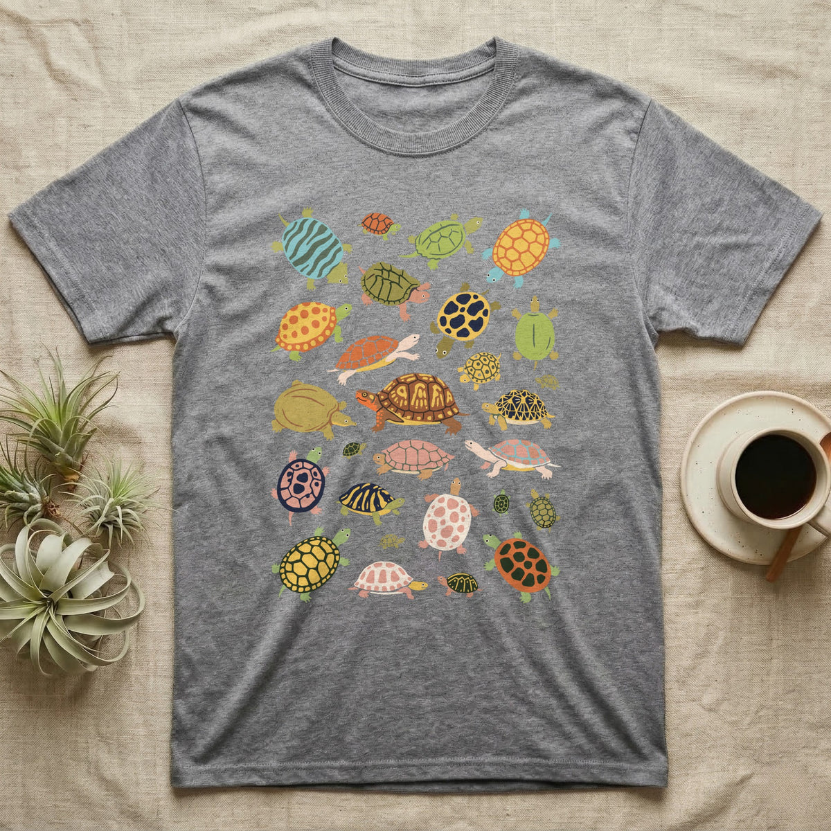 Box Turtle Specimen Plate T-Shirt in Sport Grey — Twenty-five turtles and tortoises painted flat in chalky colour, scattered across grey, each facing a different way.