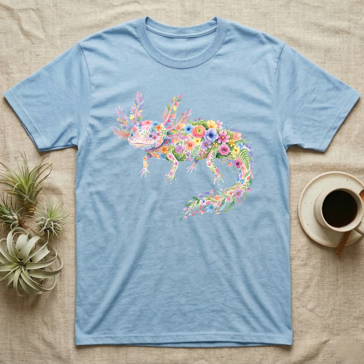 Axolotl Watercolour Mosaic T-Shirt in Light Blue — Watercolour mosaic axolotl made of painted flowers and leaf blades, gill plumes fanned, petals trailing from its tail