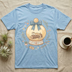Light blue t-shirt featuring a snow globe with a gecko and "Home is here" tag.
