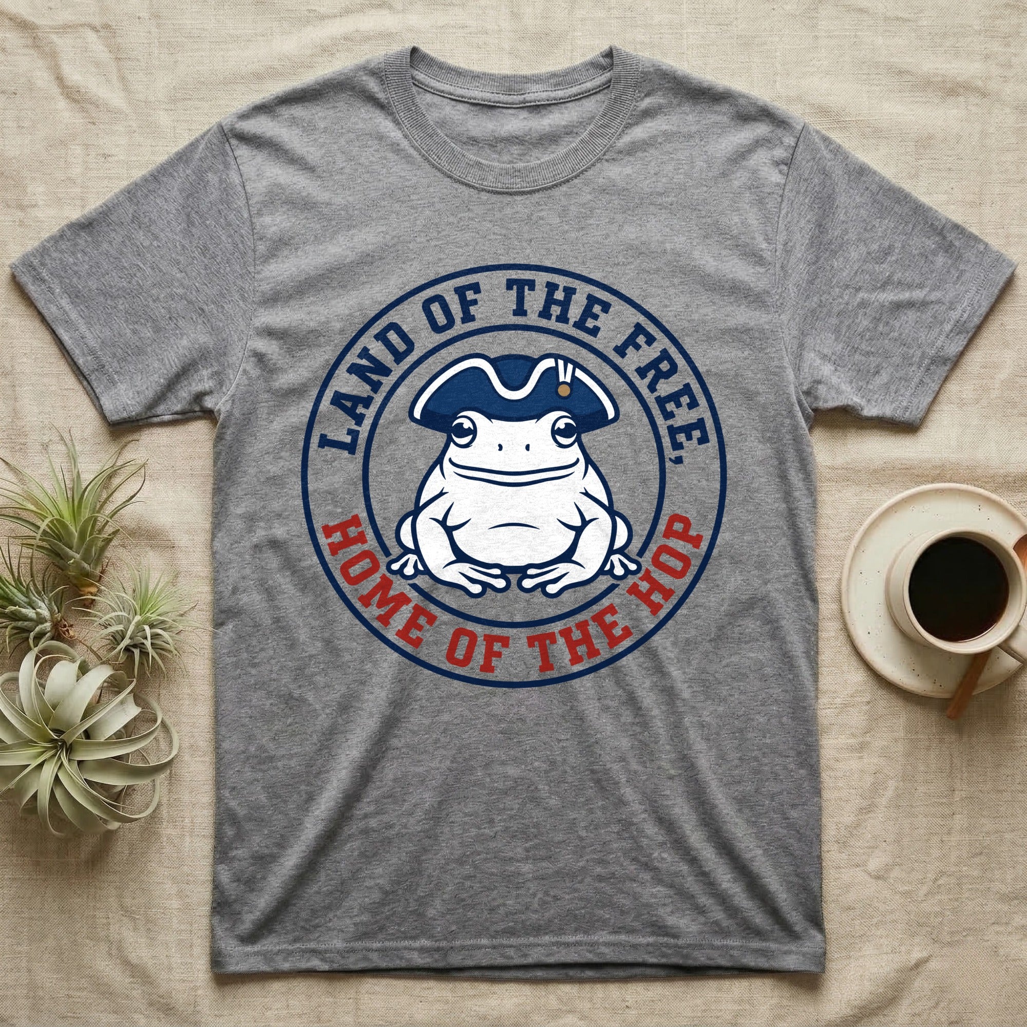 American Toad Emblem T-Shirt in Sport Grey — Round emblem of a white American toad silhouette in a tricorn hat with text Land of the Free, Home of the Hop.