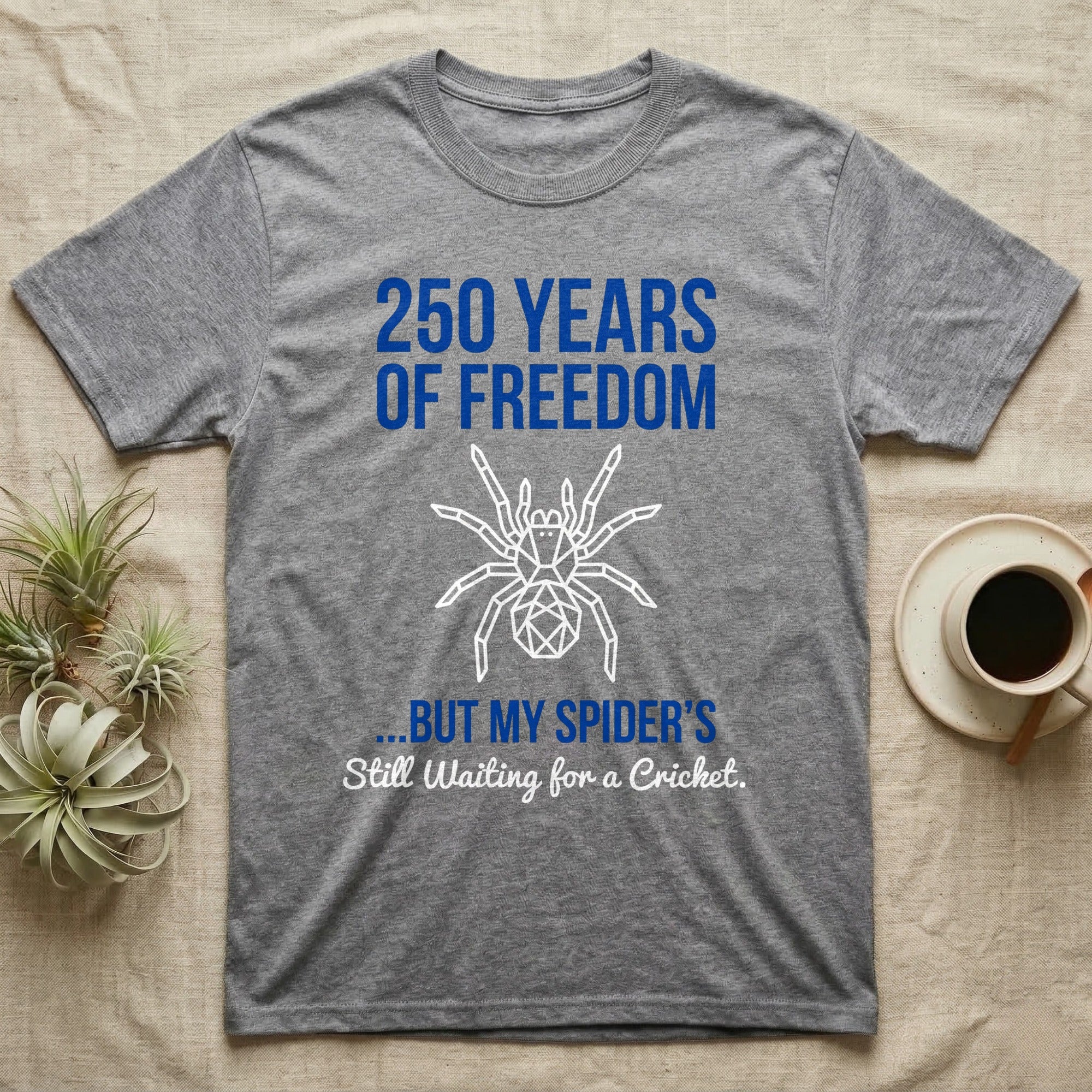Tarantula Waiting For Cricket Tee in Sport Grey — Minimalist geometric tee with a low-poly white tarantula and blue text reading 250 Years Of Freedom but my spider's still waiting for a cricket.