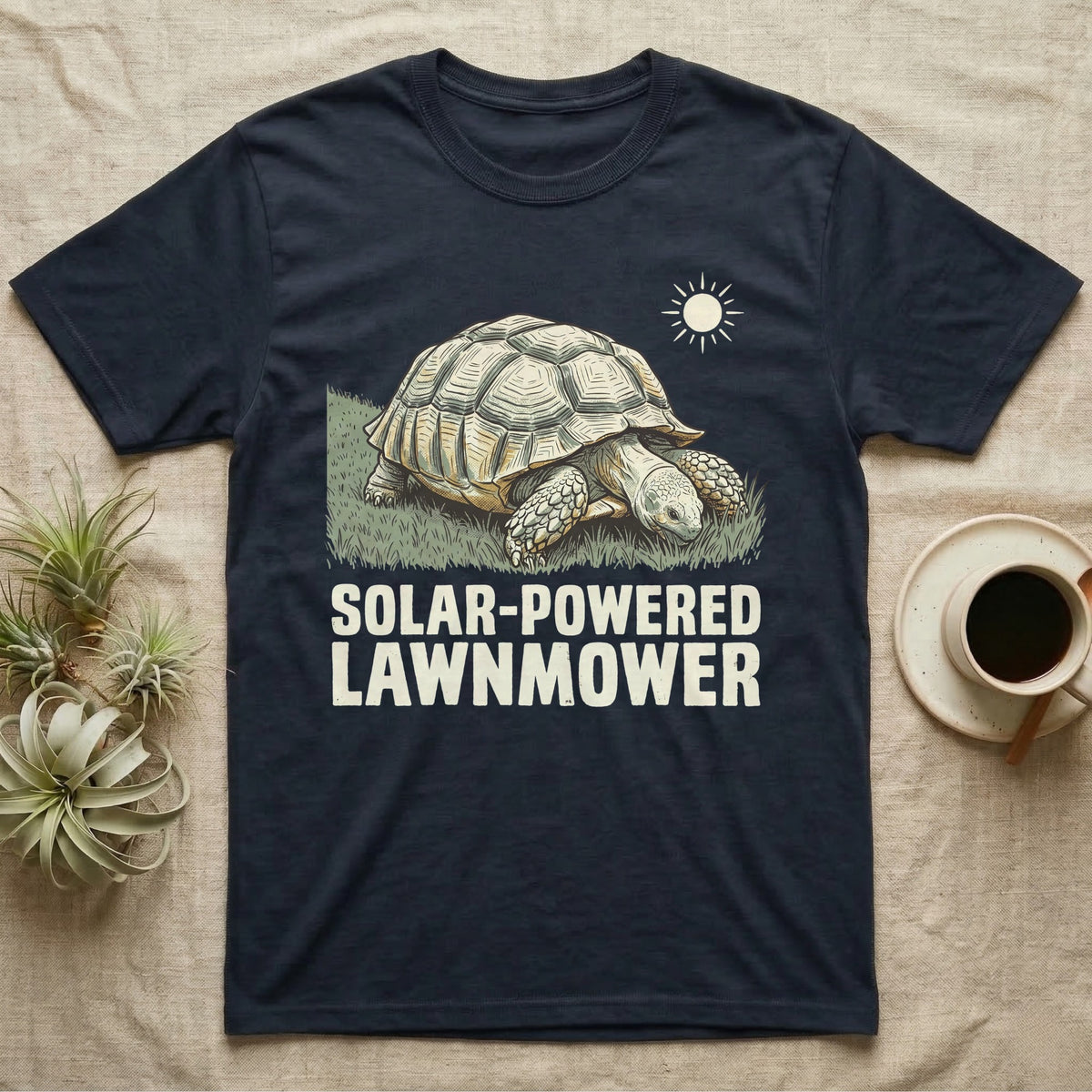Solar Powered Lawnmower T-Shirt in Navy — Retro-illustration of a sulcata tortoise grazing a lawn stripe under a sun motif with a Solar-Powered Lawnmower caption.
