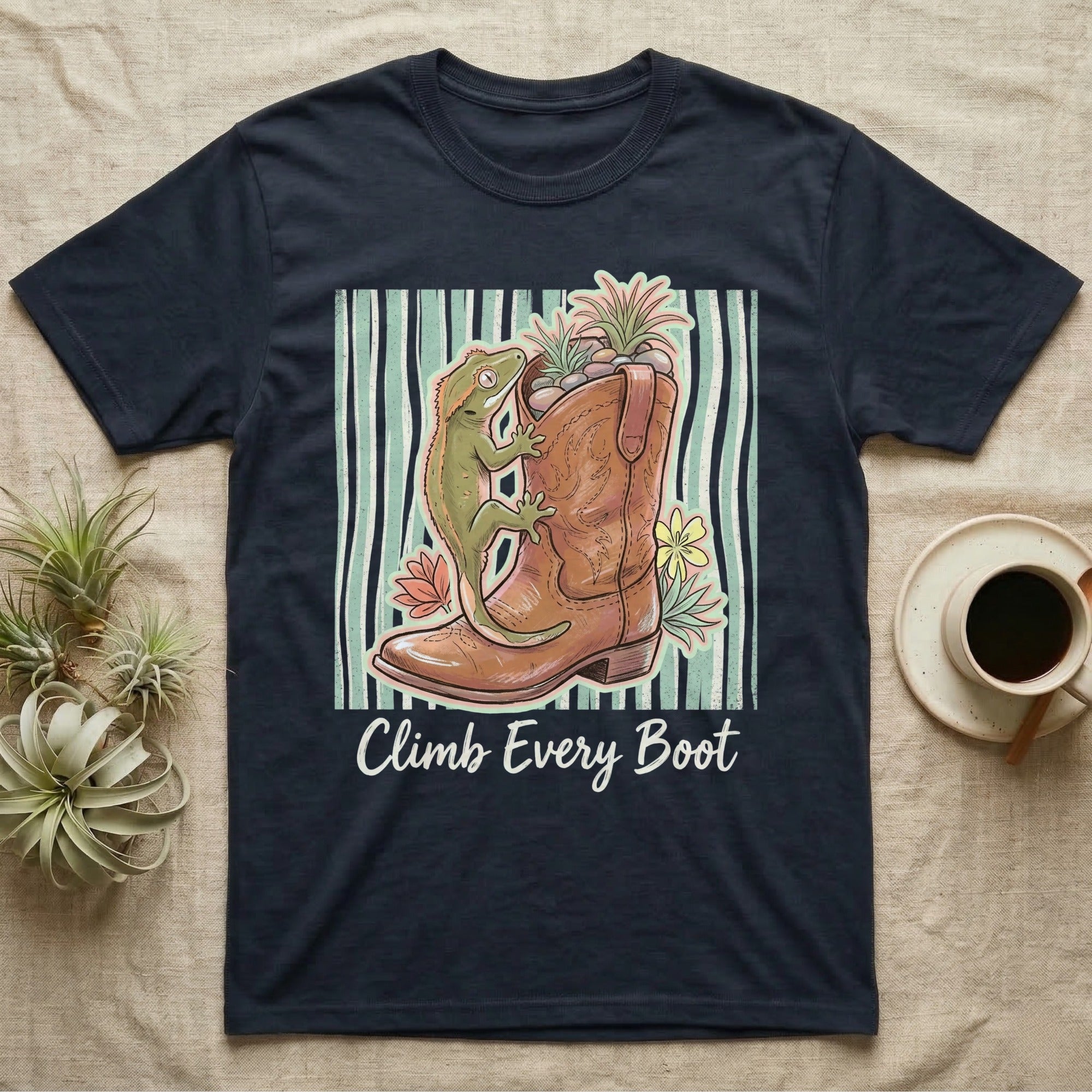 Gekko on a cowboy boot with plants and text "Climb Every Boot".