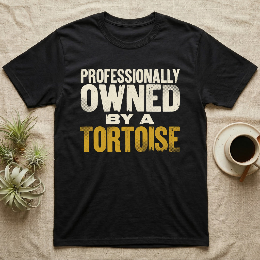 Owned By A Tortoise T-Shirt in Black — Distressed woodtype wordmark reading professionally owned by a tortoise in a bold two-tier lockup, text only.