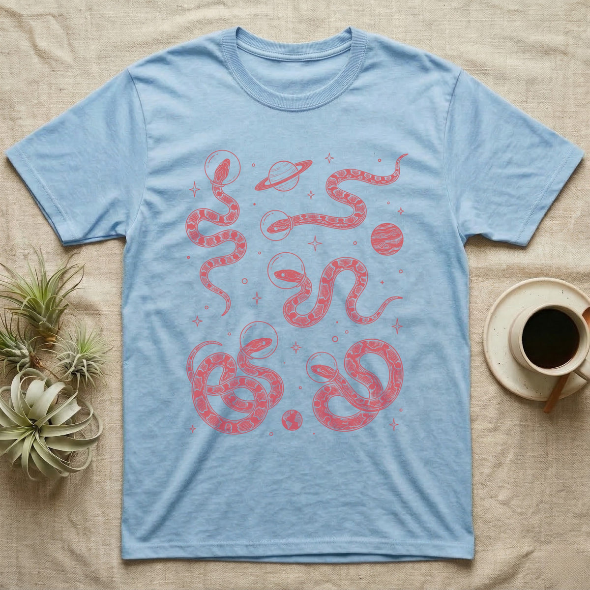 Corn Snake Cosmic T-Shirt in Light Blue — Vintage screen-print illustration of corn snakes in astronaut helmets floating in space, cosmic crimson monochromatic on dark background.