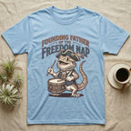 Bearded Dragon Drummer T-Shirt in Light Blue — Sepia woodcut bearded dragon as a Revolutionary drummer boy under ornate text Founding Father of the Freedom Nap.