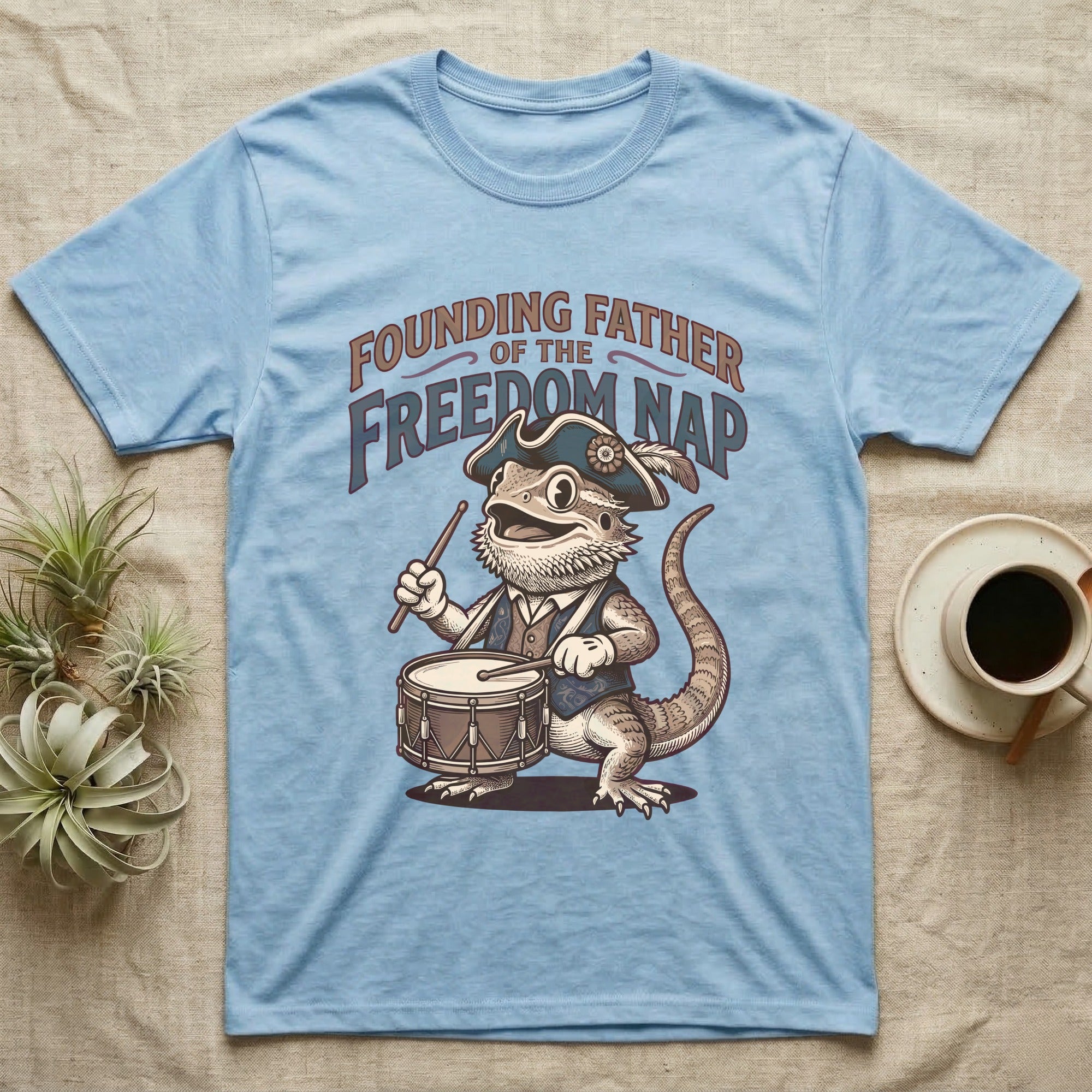Bearded Dragon Drummer T-Shirt in Light Blue — Sepia woodcut bearded dragon as a Revolutionary drummer boy under ornate text Founding Father of the Freedom Nap.